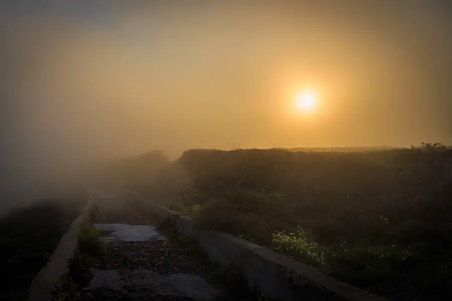 Misty morning path from Imerovigli to Oia at sunrise