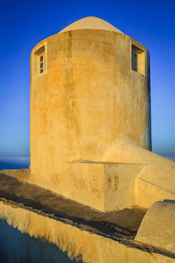 One of the windmill buildings of Santorini at sunrise