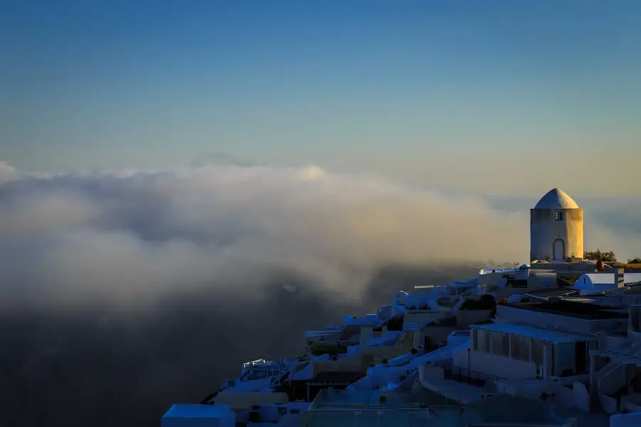 Iconic view of a Santorini windmill at sunrise