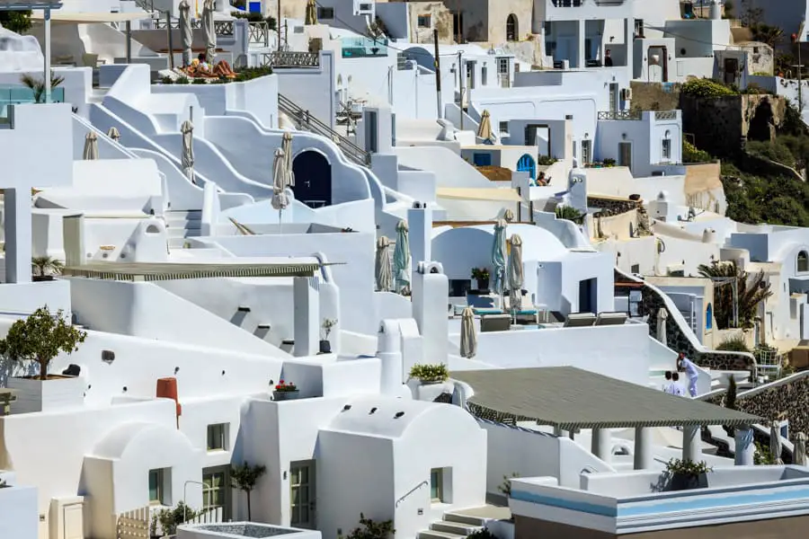 Close up of some of the white buildings of Santorini showing all those closed sun umbrellas